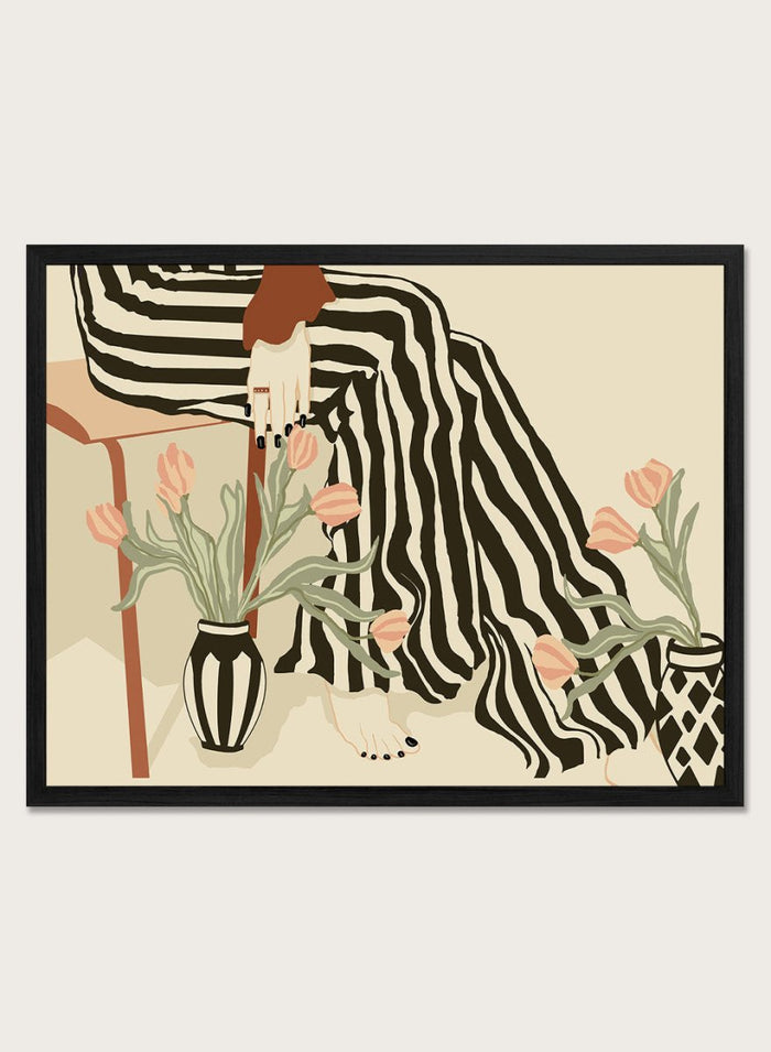Artistic depiction of a person with striped pants sitting on a chair with floral arrangements. Tulips By My Feet by Sannel Larson is a modern minimalist art print with woman in striped pants and soft tulips. Officially licensed wall poster with framing.