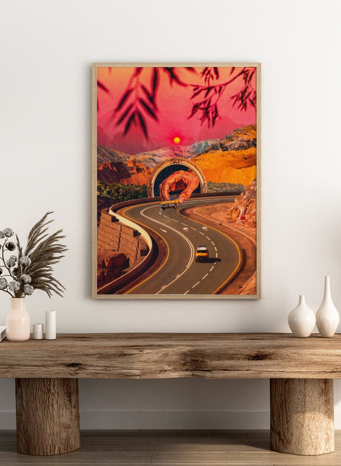 Winding road with a large hand-like structure in a desert landscape during sunset. Play Time by Taudalpoi surreal retro road trip art print with giant hand, desert highway and vintage car collage, cosmic inspired poster wall art.
