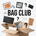 An open box of OTG|247 pouches in assorted colours and prints, with question marks for the surprise bags, under The Bag Club logo.