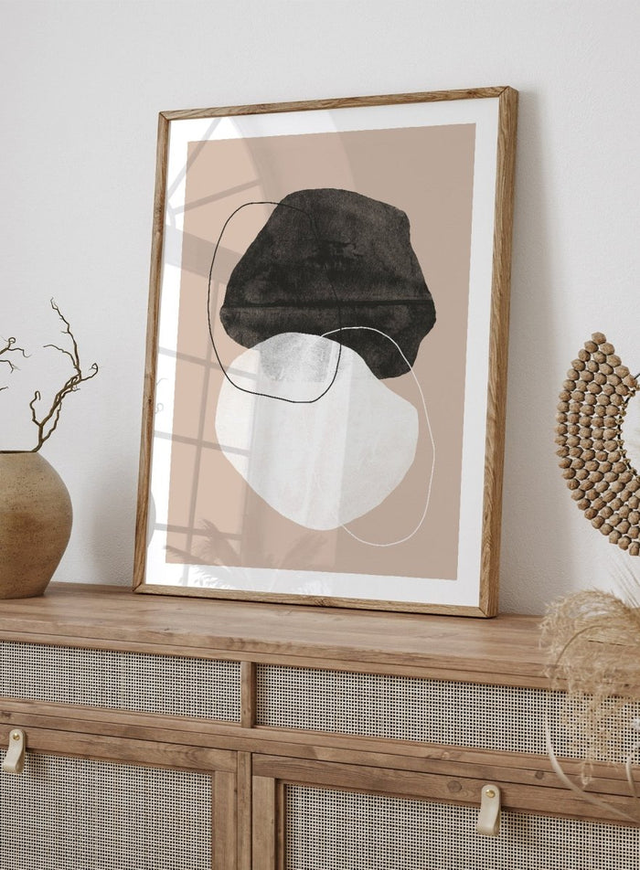 Abstract art piece with a black shape and white circle on a beige background. Earthy Abstractions by The MIUUS Studio is a minimalist abstract art print and wall poster featuring organic shapes, neutral tones, and modern textured design.