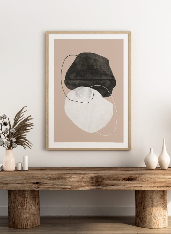 Abstract art piece with a black shape and white circle on a beige background. Earthy Abstractions by The MIUUS Studio is a minimalist abstract art print and wall poster featuring organic shapes, neutral tones, and modern textured design.