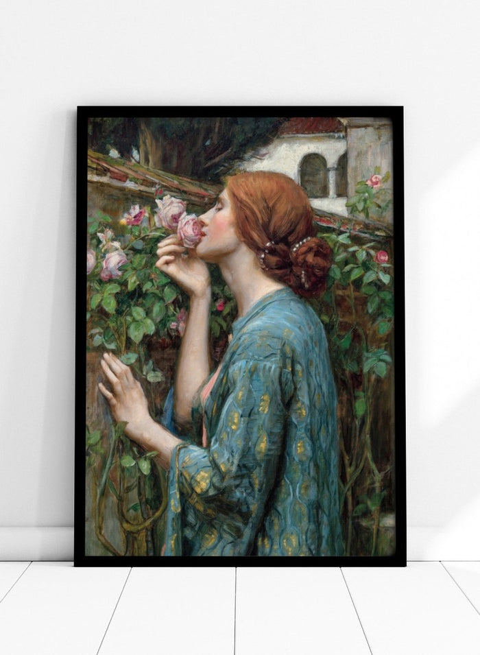 The Soul of the Rose by John William Waterhouse is a vintage floral print of a woman smelling roses in a garden, wearing a blue and gold gown.