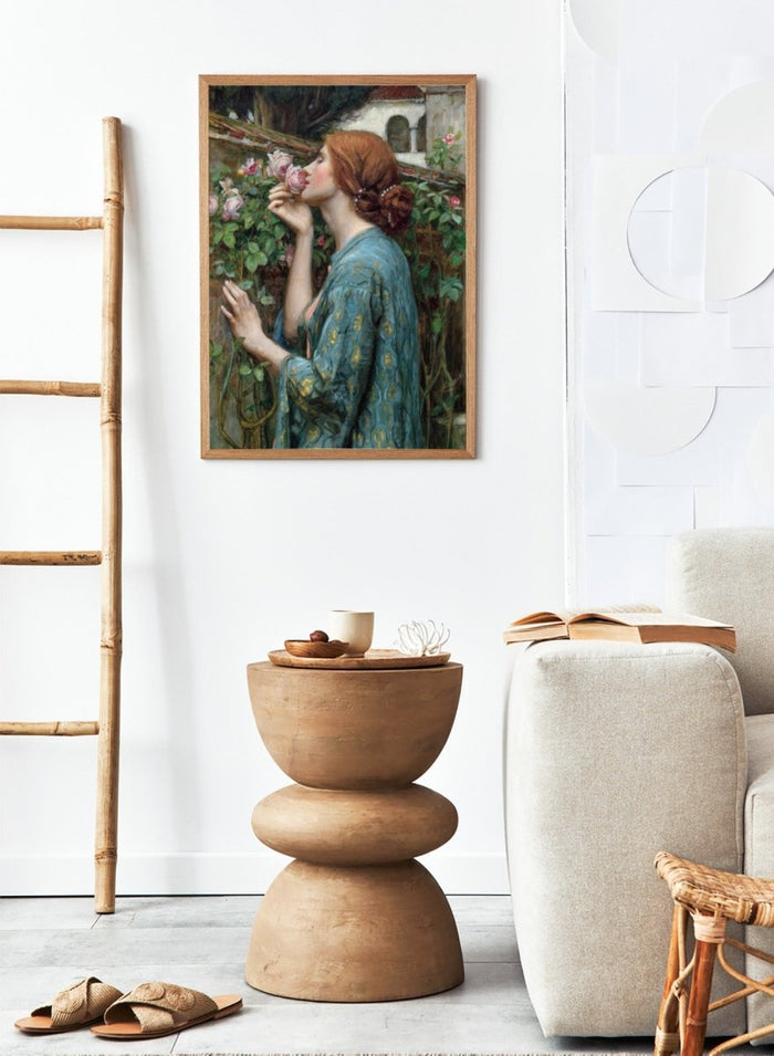 The Soul of the Rose by John William Waterhouse is a vintage floral print of a woman smelling roses in a garden, wearing a blue and gold gown.