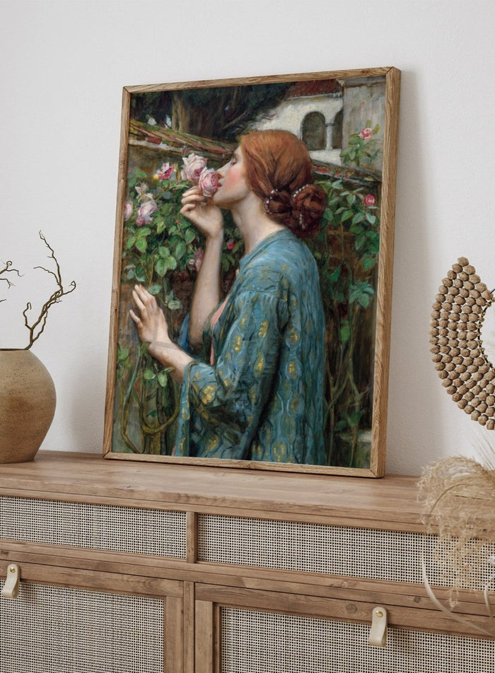 The Soul of the Rose by John William Waterhouse is a vintage floral print of a woman smelling roses in a garden, wearing a blue and gold gown.