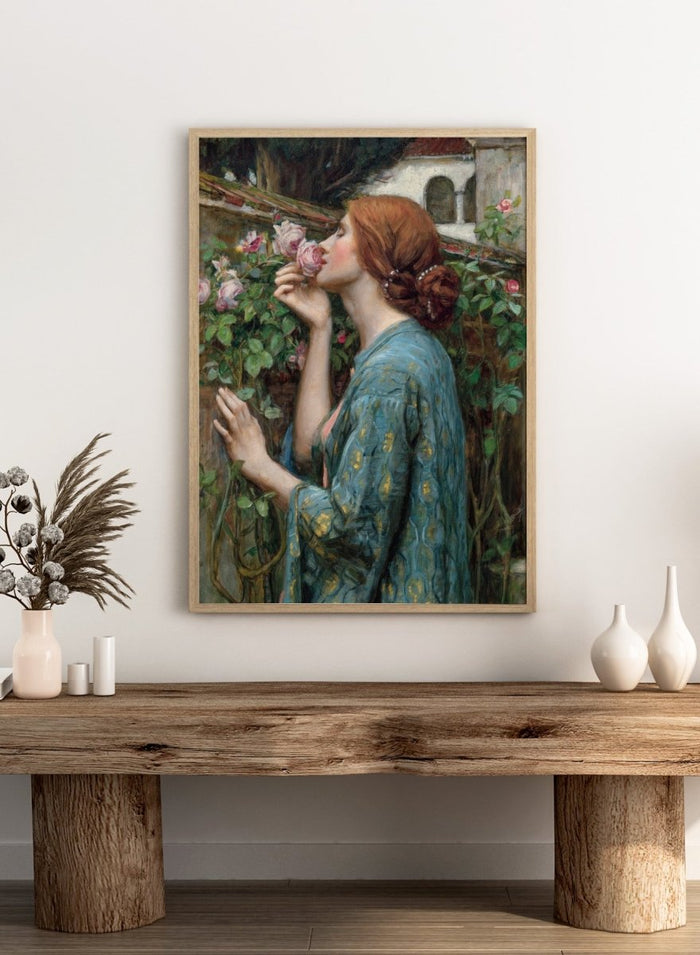 The Soul of the Rose by John William Waterhouse is a vintage floral print of a woman smelling roses in a garden, wearing a blue and gold gown.