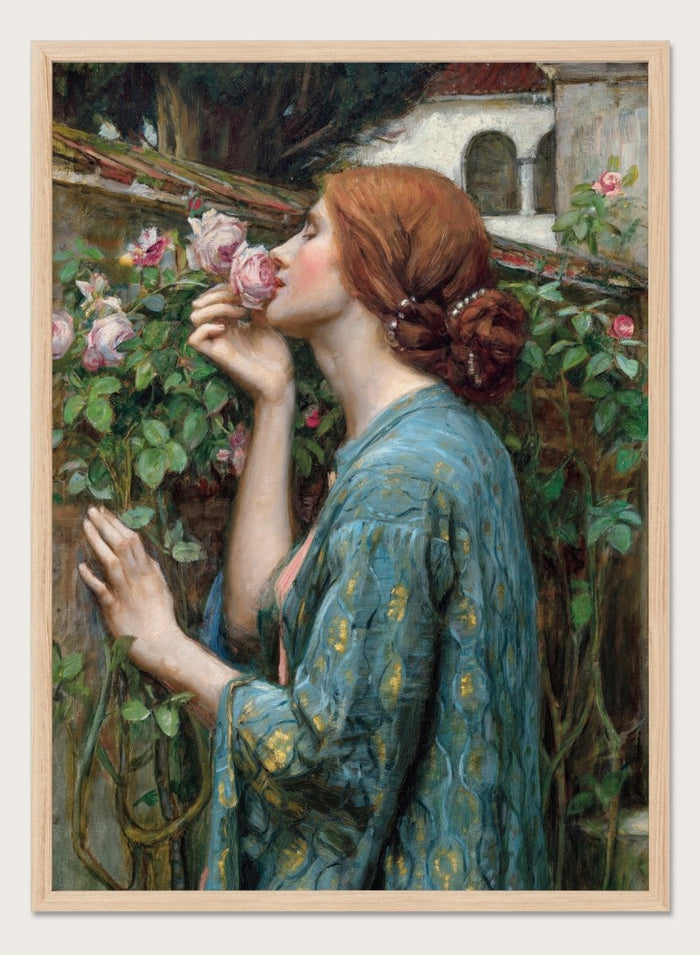 The Soul of the Rose by John William Waterhouse is a vintage floral print of a woman smelling roses in a garden, wearing a blue and gold gown.