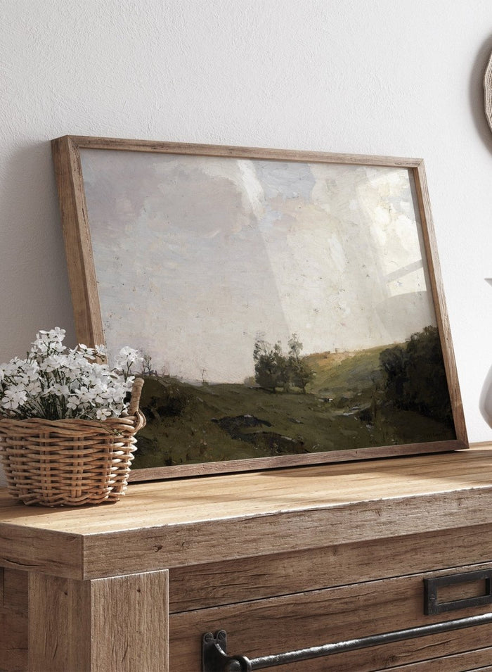 The Three Trees by William Langson Lathrop is a vintage tonalist landscape print of a green field and cloudy sky, a calming countryside wall art print.