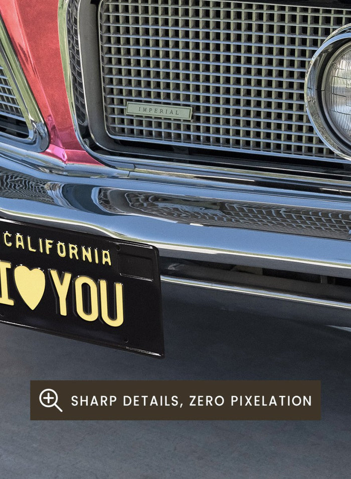 Pink vintage car with 'I ❤️ YOU' license plate against a pink sky. P.S. I Love You by Tom Windeknecht is officially licensed photography featuring a vibrant pop-art style photo of a car with romantic typography. Framed or unframed.