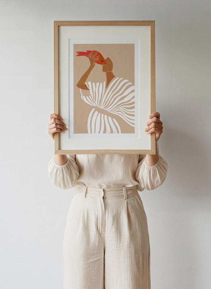 Fish Eye Paradox by Uma Gokhale is a figurative art print showing a woman holding a fish in an intimate portrait. Premium fine art print with real wood framing.